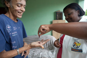 photo of a nurse giving a patient his medicine