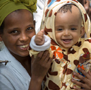 A mother and baby smiling