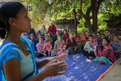 A woman addresses a community group