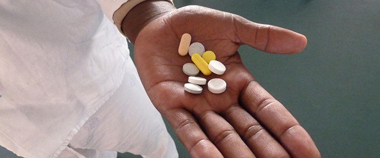 Photo of a hand holding several pills