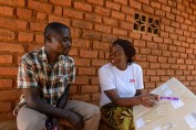 Photo of a woman showing contraceptive options to a man.